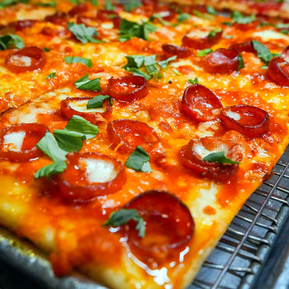 Pepperoni grandma pie with fresh basil